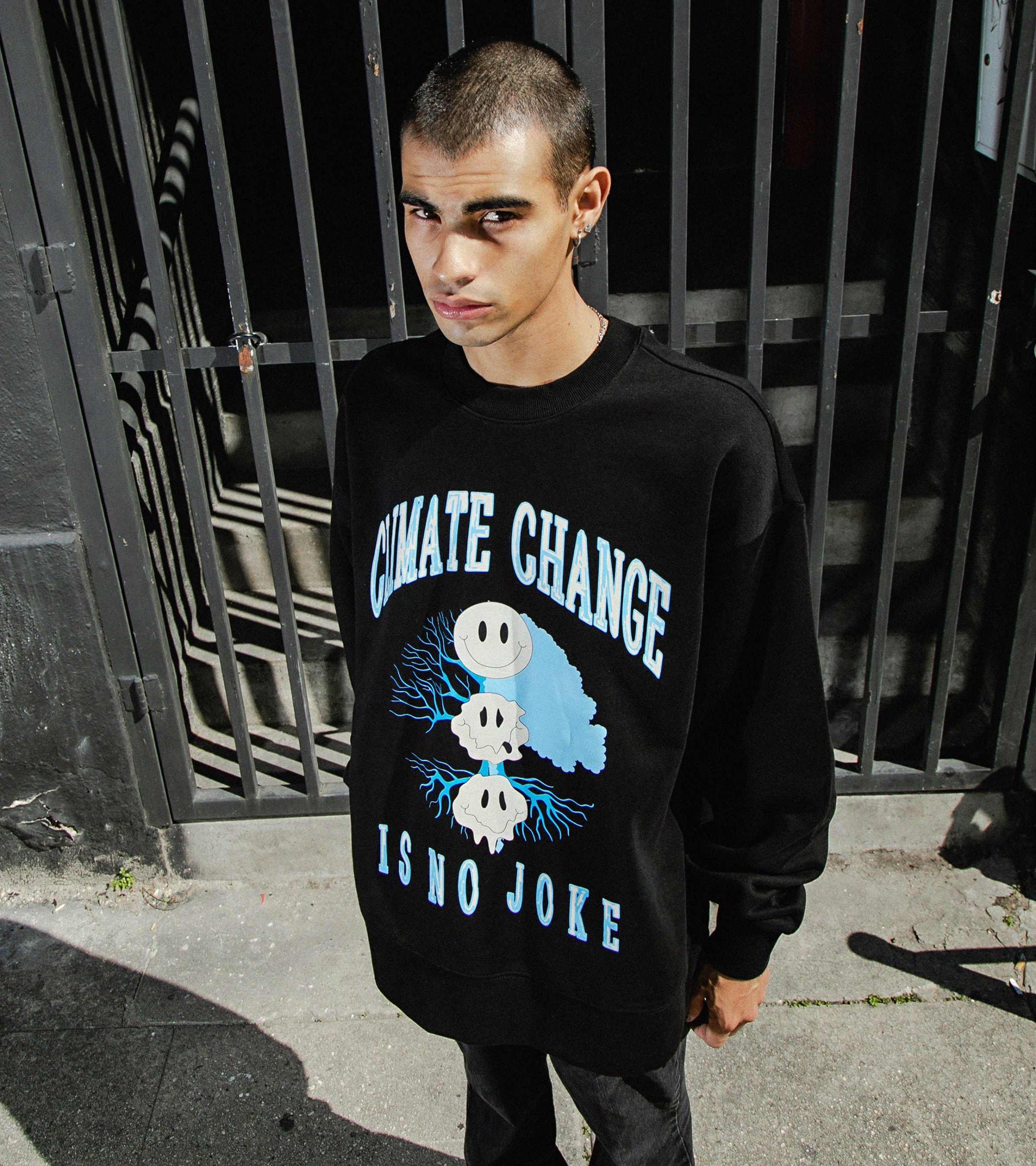 Medium-shot of male model in Climate Change Is No Joke relaxed fit oversized heavyweight crewneck sweatshirt in black