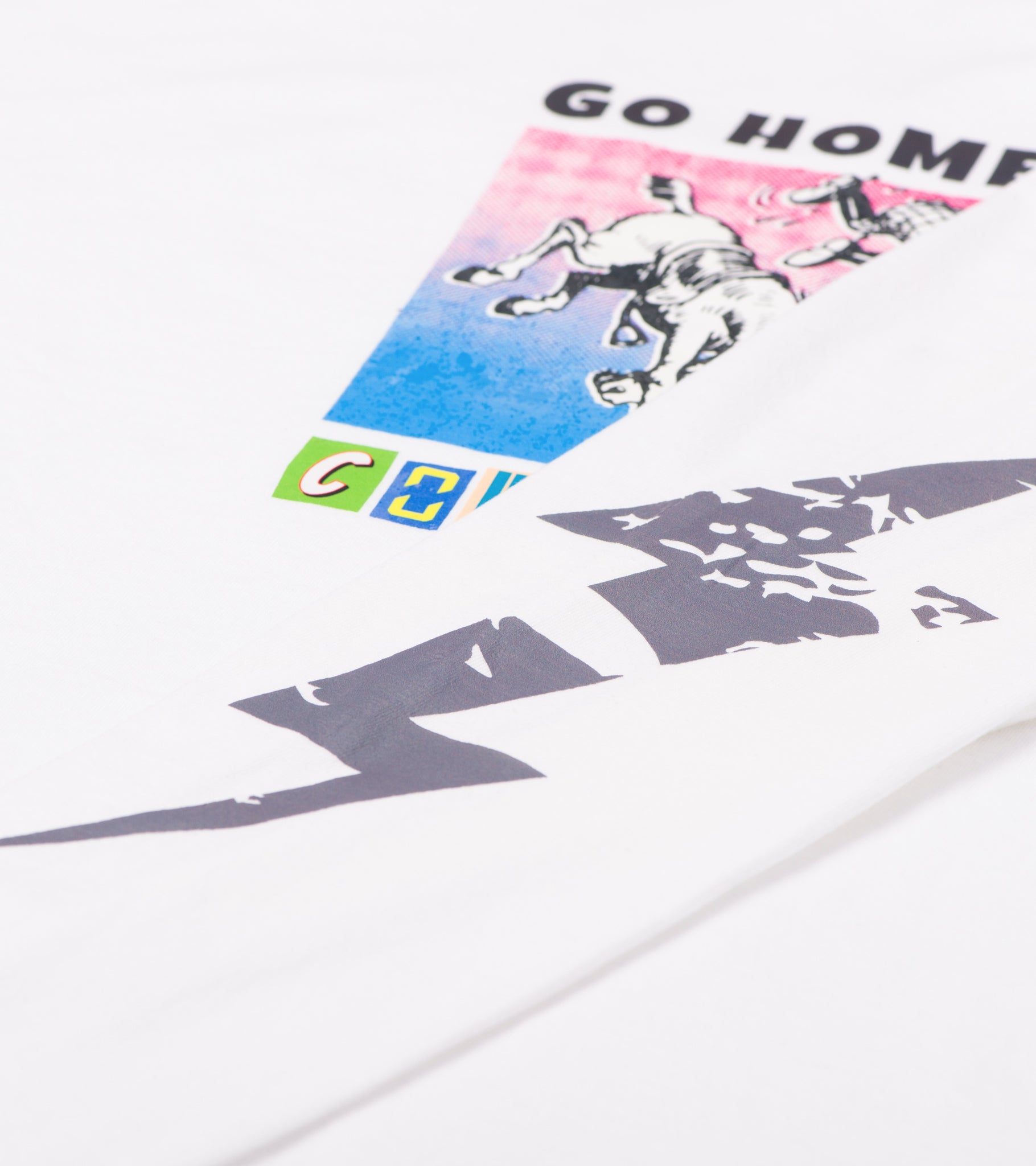 Close-up of Go Home Cowboy front print with cowboy and horse graphic and gray lightning bolt sleeve print