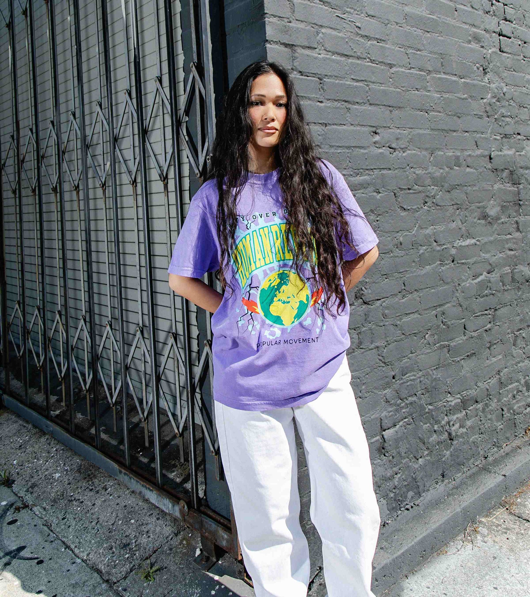 Medium shot of beautiful woman model wearing summery violet colored unisex cotton graphic t-shirt